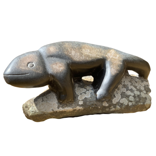 A shona springstone sculpture of a salamander basking on a rock.