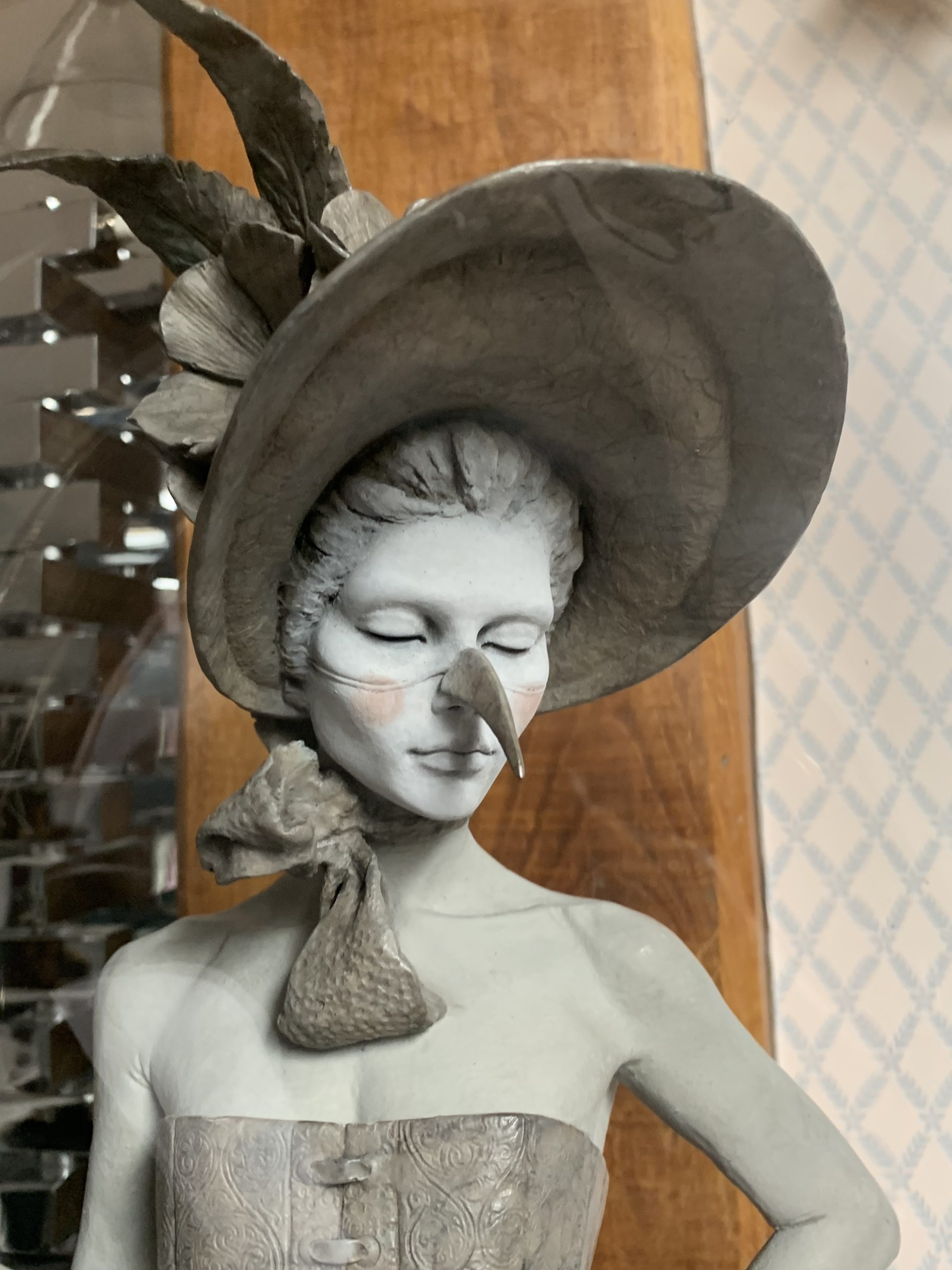 Bronze sculpture of a female figure wearing a corset, bloomers and hat. Her bustle is adorned with Taxidermy humming birds. Encased in Victorian glass dome, edition signed.