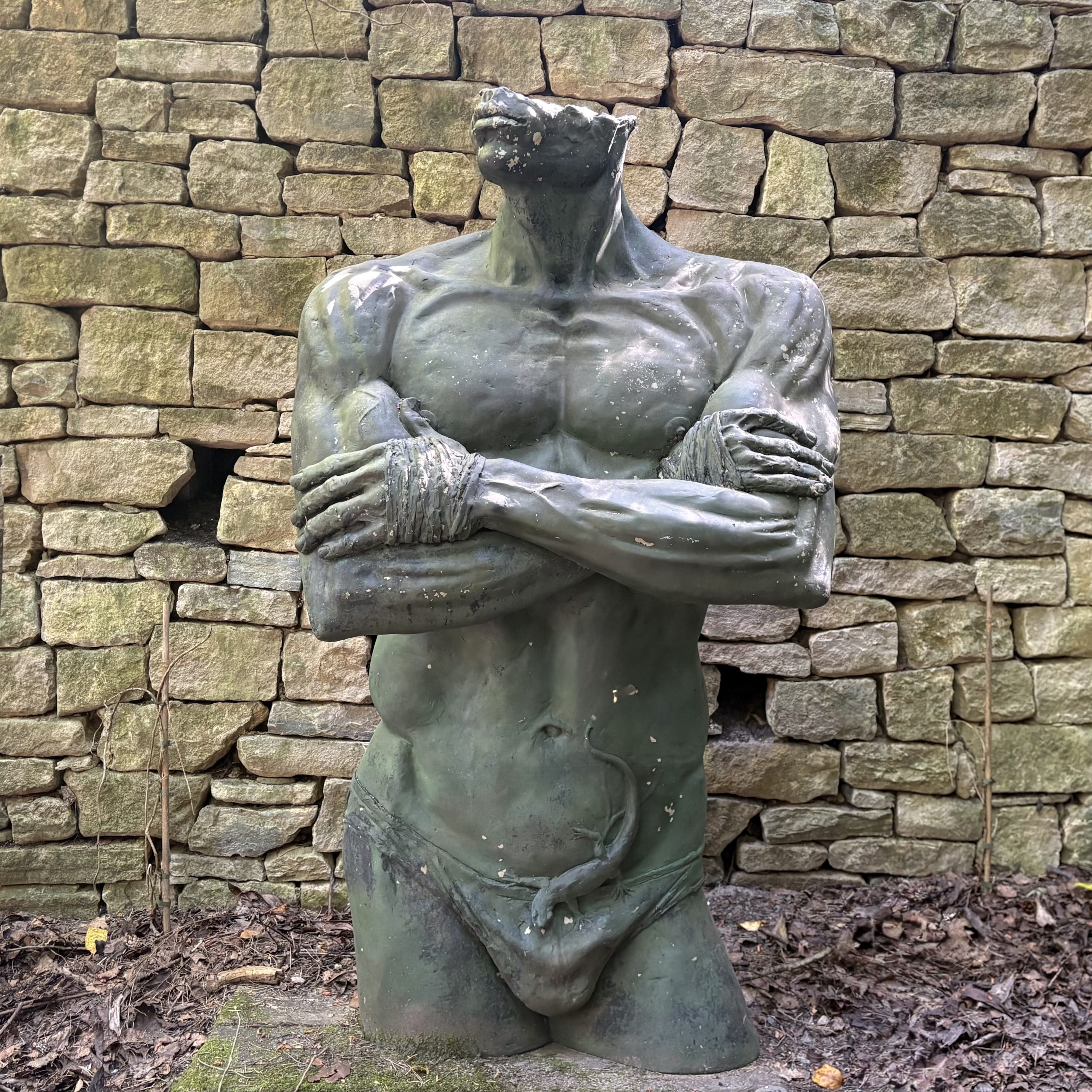 Natura Pudorum Virium Contegit (Nature covers up the shame of strength) by Ian Rank-Broadley is a Monumental Figurative Sculpture of a Man's Torso, arms folded, wearing a Lizard and loin cloth