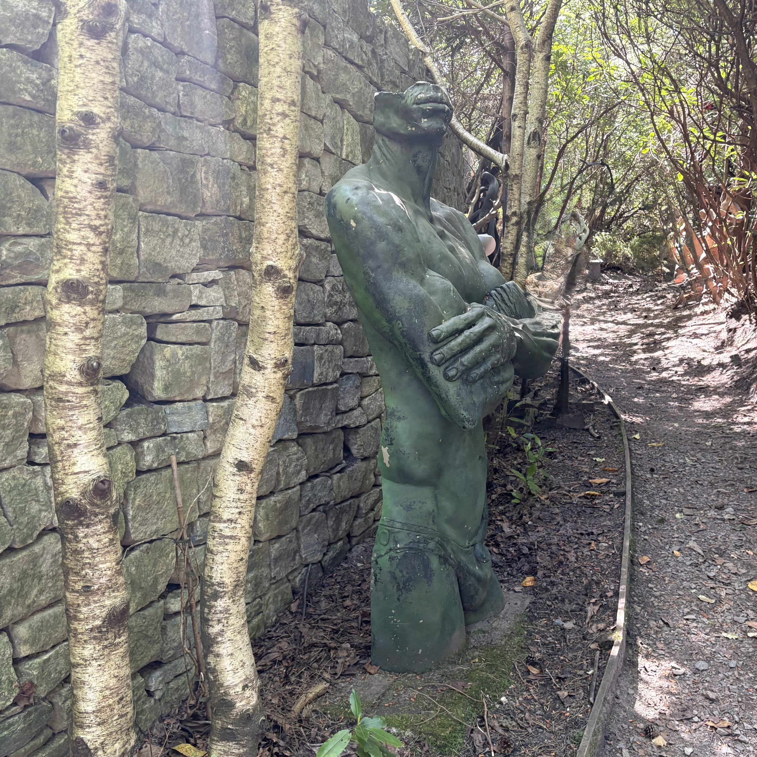 Natura Pudorum Virium Contegit (Nature covers up the shame of strength) by Ian Rank-Broadley is a Monumental Figurative Sculpture of a Man's Torso, arms folded, wearing a Lizard and loin cloth