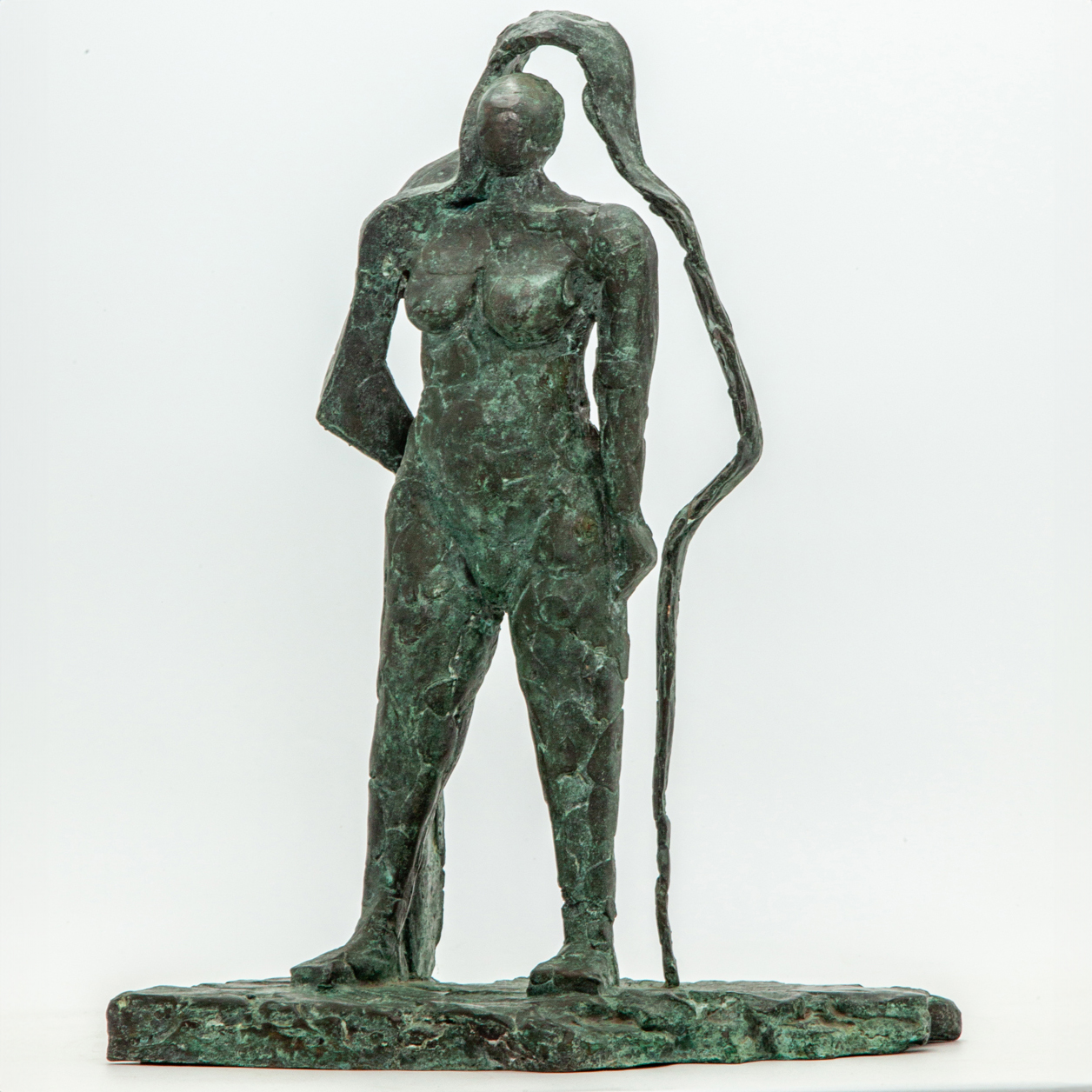 Abstract bronze sculpture of a figure standing with their shadow