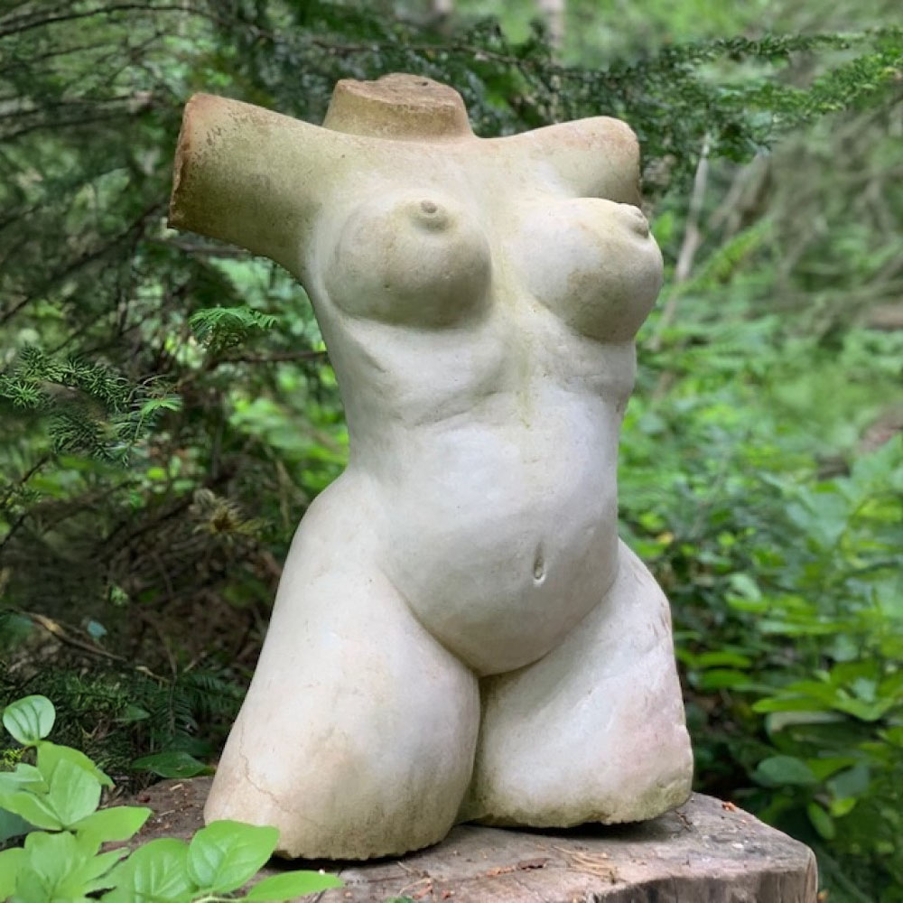 A shona stone sculpture of a woman's bare torso.