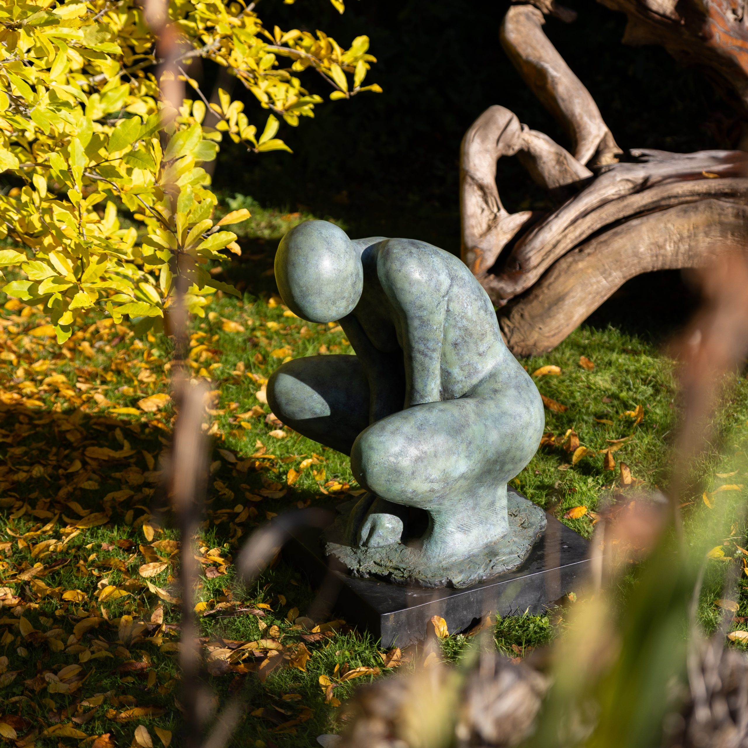 A stylised minimalist sculpture of a crouching woman