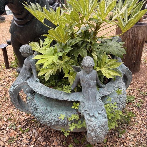 Bronze Antique Planter elaborately decorated with cherubs and roses. A grand garden feature or suitable for indoor display.