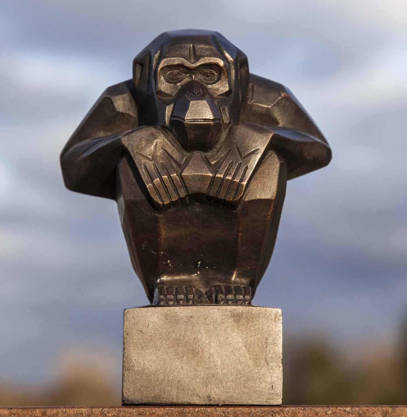 Art Deco Monkey is a small bronze monkey in a crouching position with his hands resting on his knees