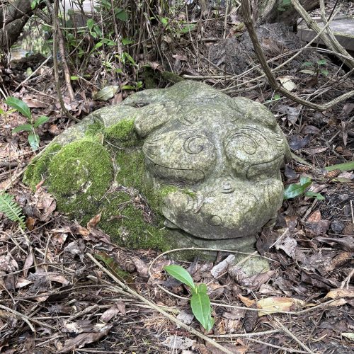 Oriental Laying Dragon is a figurative marble sculpture which has been weathered and aged giving an antique fee, suitable for garden display.