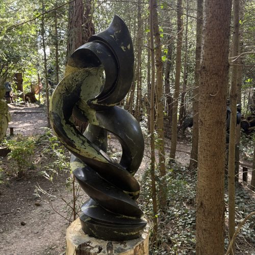 Stillness in Motion by Macdonald Kufa is a flowing abstract Zimbawean Shona Leopard Rock sculpture suitable for indoor or outdoor display