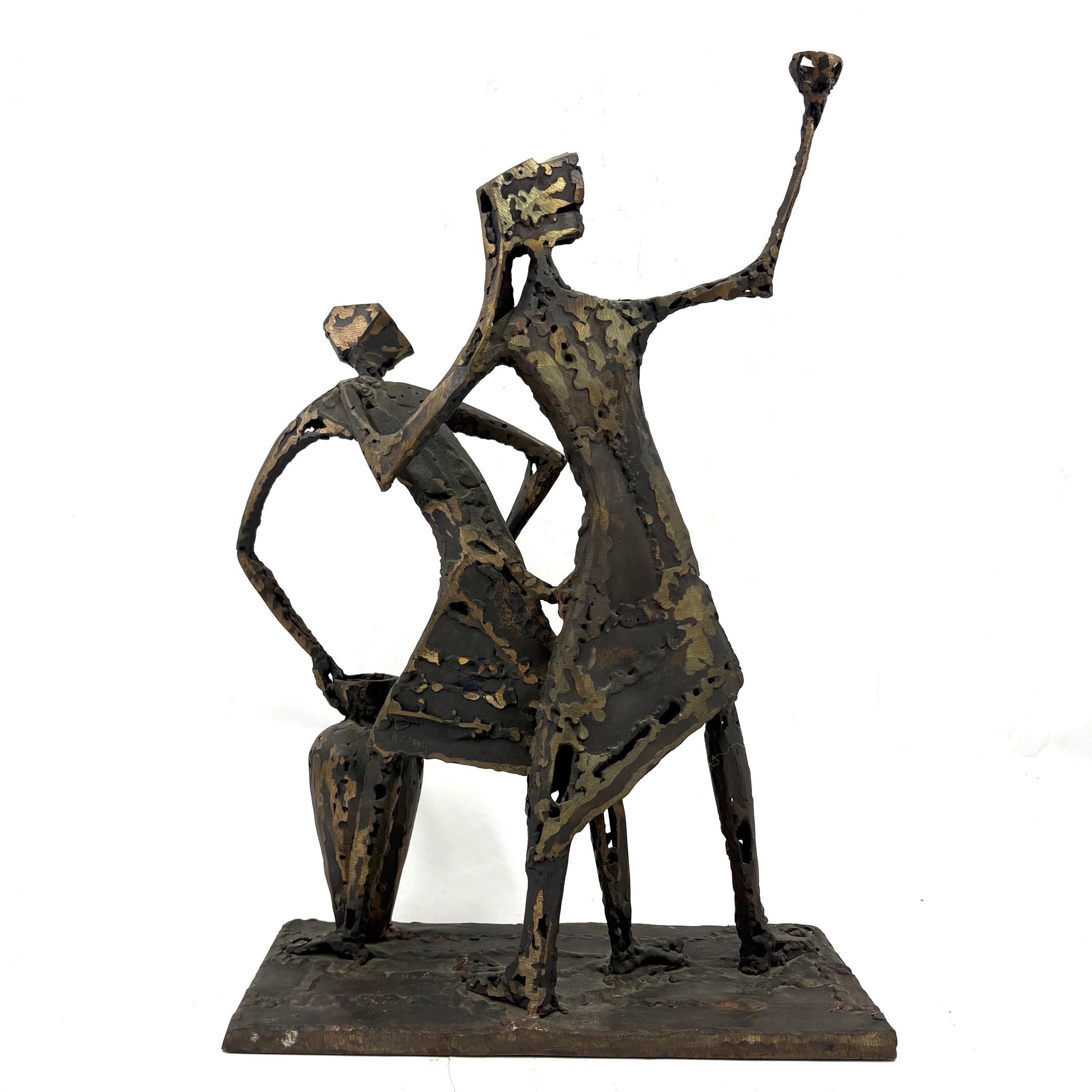 Two Figures by Sean Crampton. A unique sculpture made from welded bronze depicting two figures standing side by side along with a large vessel or vase.