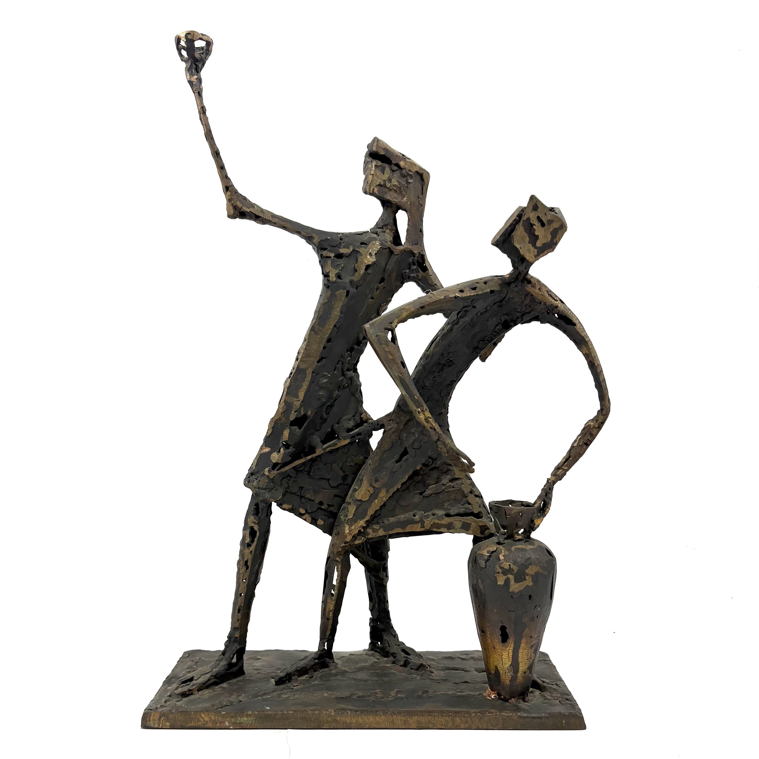Two Figures by Sean Crampton. A unique sculpture made from Welded Bronze which shows two abstract figures. One figure leans on a large vase while the other holds a hand up in the air and is perhaps holding a cup.