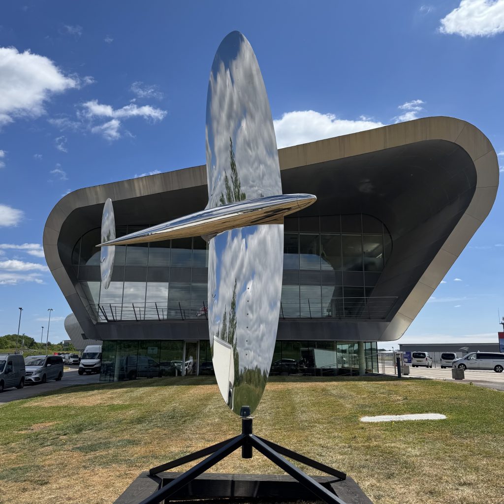 Spitfire MKIII by Richard Cresswell is a kinetic wind powered spinning mirror polished stainless steel sculpture of a war aeroplane