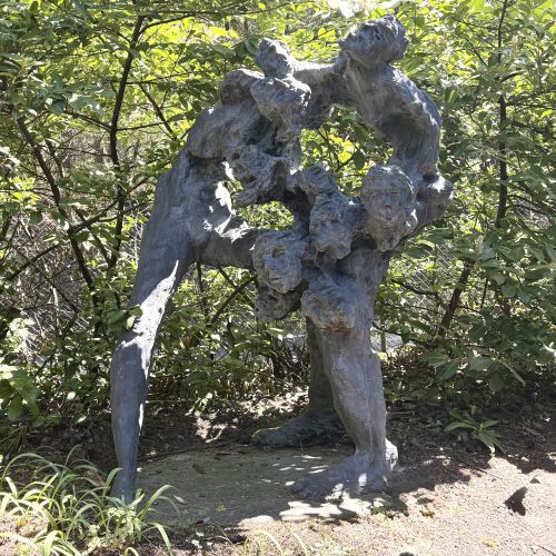 A Family of Faces by Won Lee. A large bronze sculpture of an abstract, expressionist style family group.