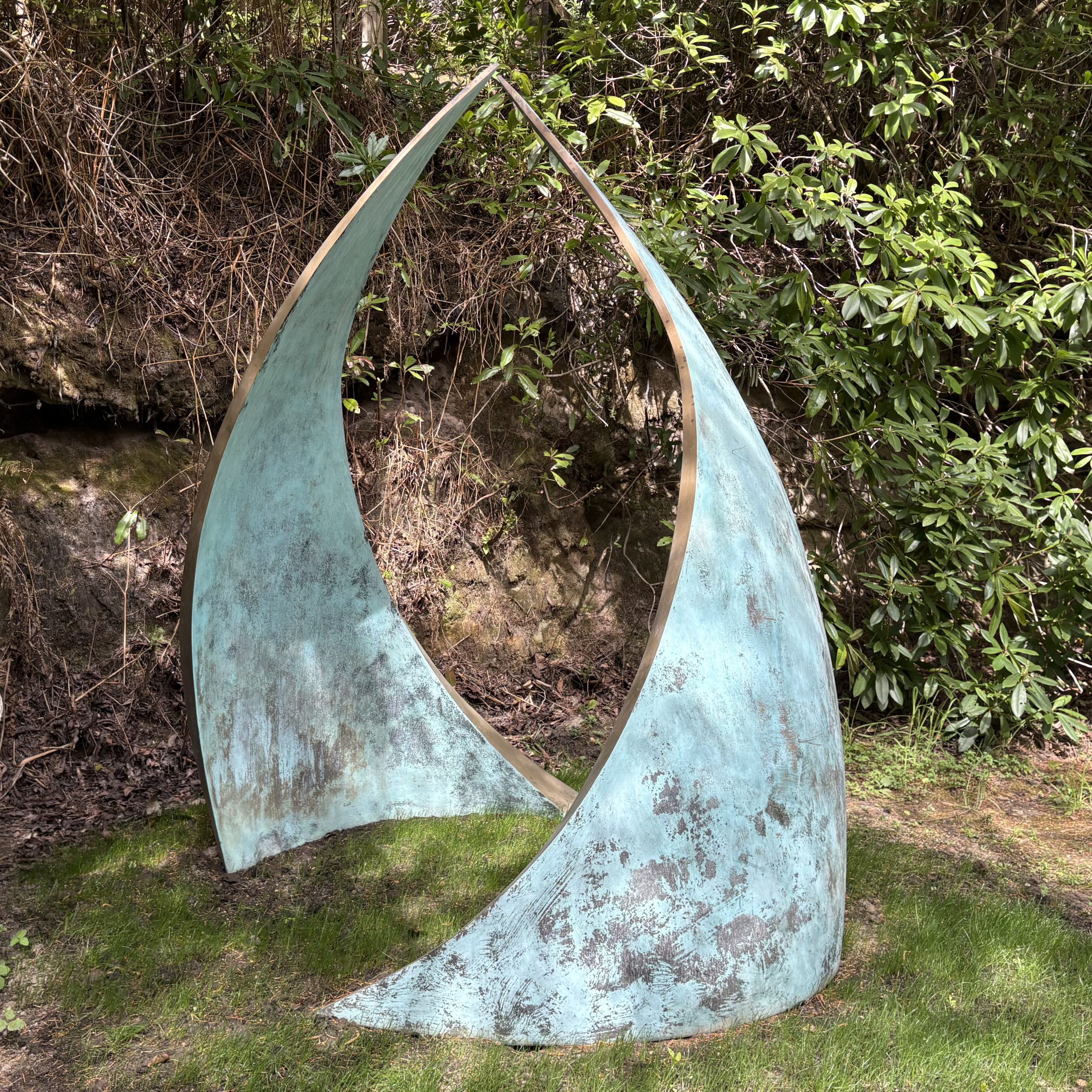 Embrace by Simon Gudgeon. Monumental abstract bronze sculpture of two wave like two forms that arch in towards each other.