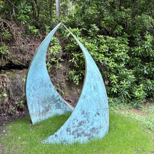 Embrace by Simon Gudgeon. Monumental abstract bronze sculpture of two wave like two forms that arch in towards each other.