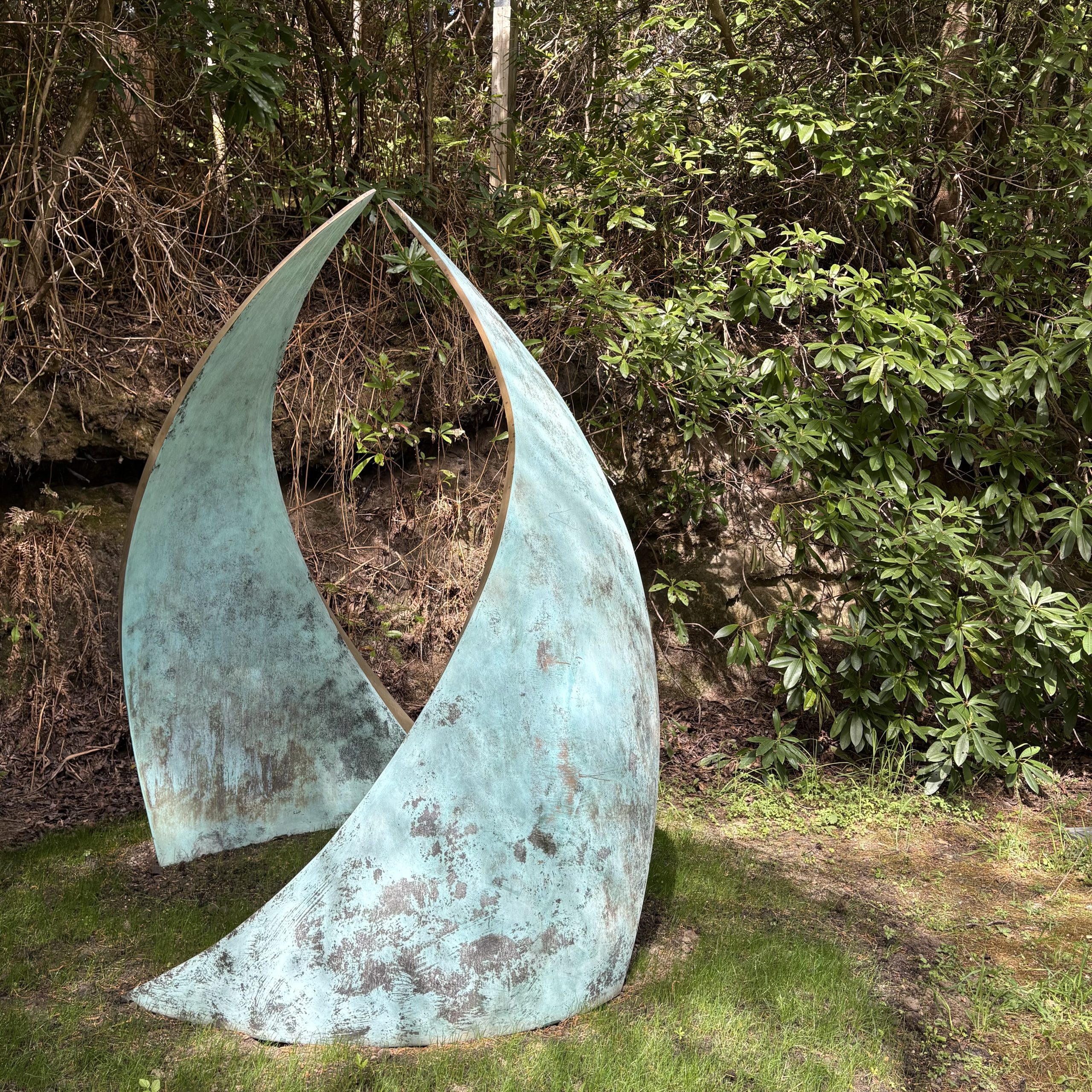 Embrace by Simon Gudgeon. Monumental abstract bronze sculpture of two wave like two forms that arch in towards each other.