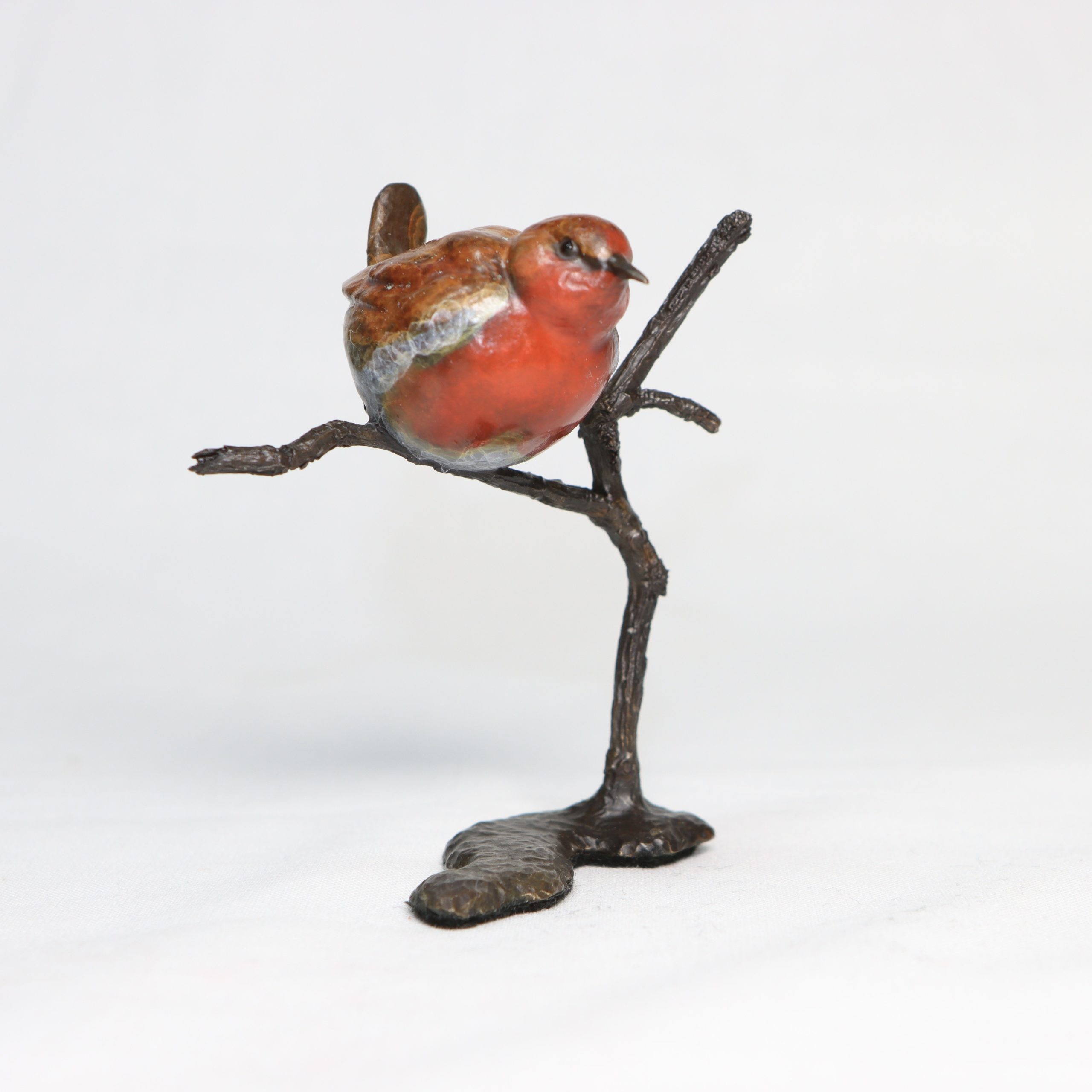 Robin on Branch by Steve Boss A delightful miniature bronze sculpture of a charming robin balanced on top of a tree branch.
