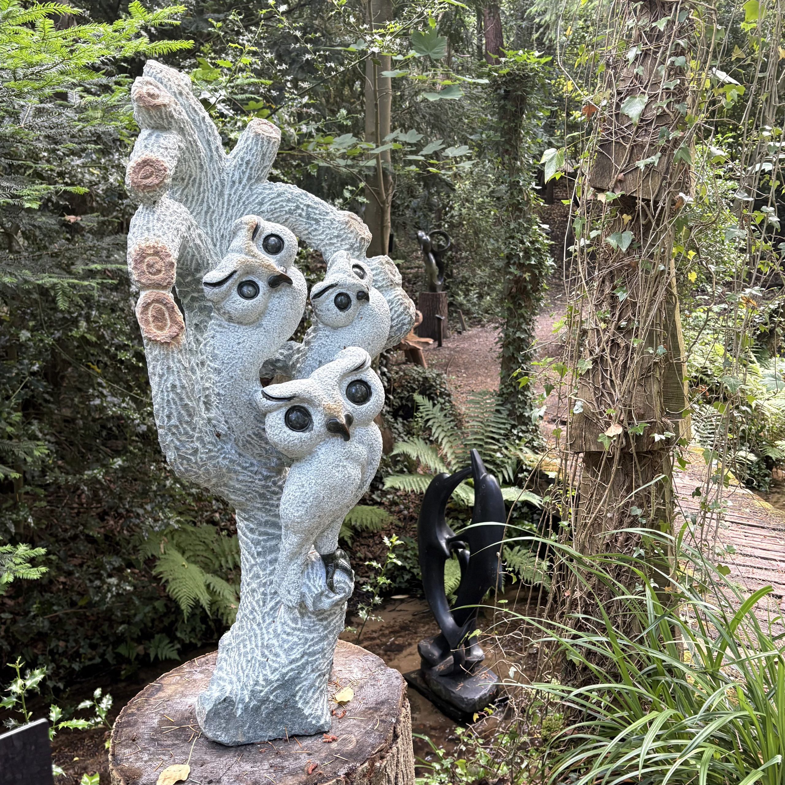Together We Grow by Taurai Mupaso. Unique, large, Shona sculpture of three owls perched together in a tree. Carved from opal stone.