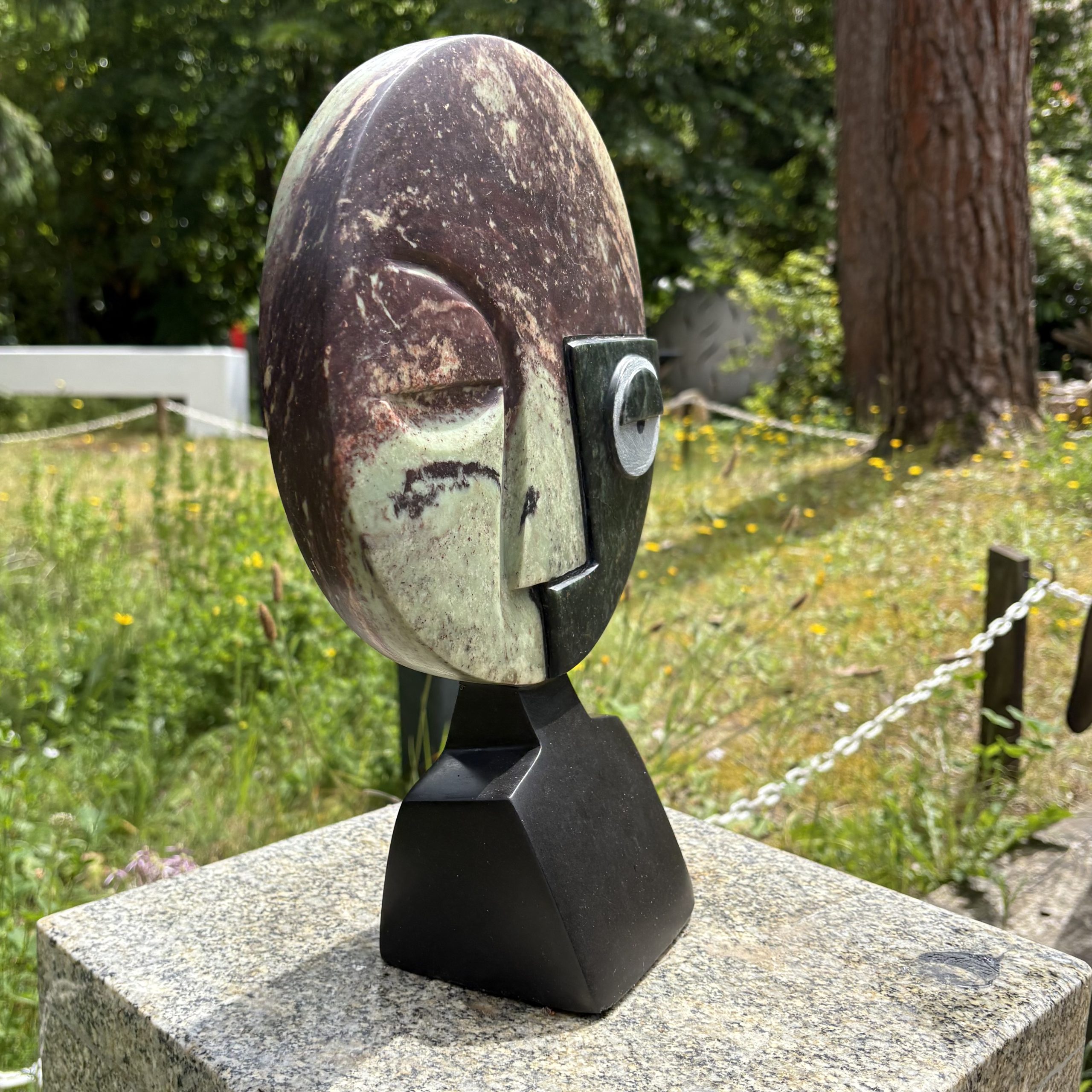 Visionary by Taylor Nkom. A unique, Cobalt, Opal and Springstone Shona sculpture of an abstract style face. The different stones add definition and colour.