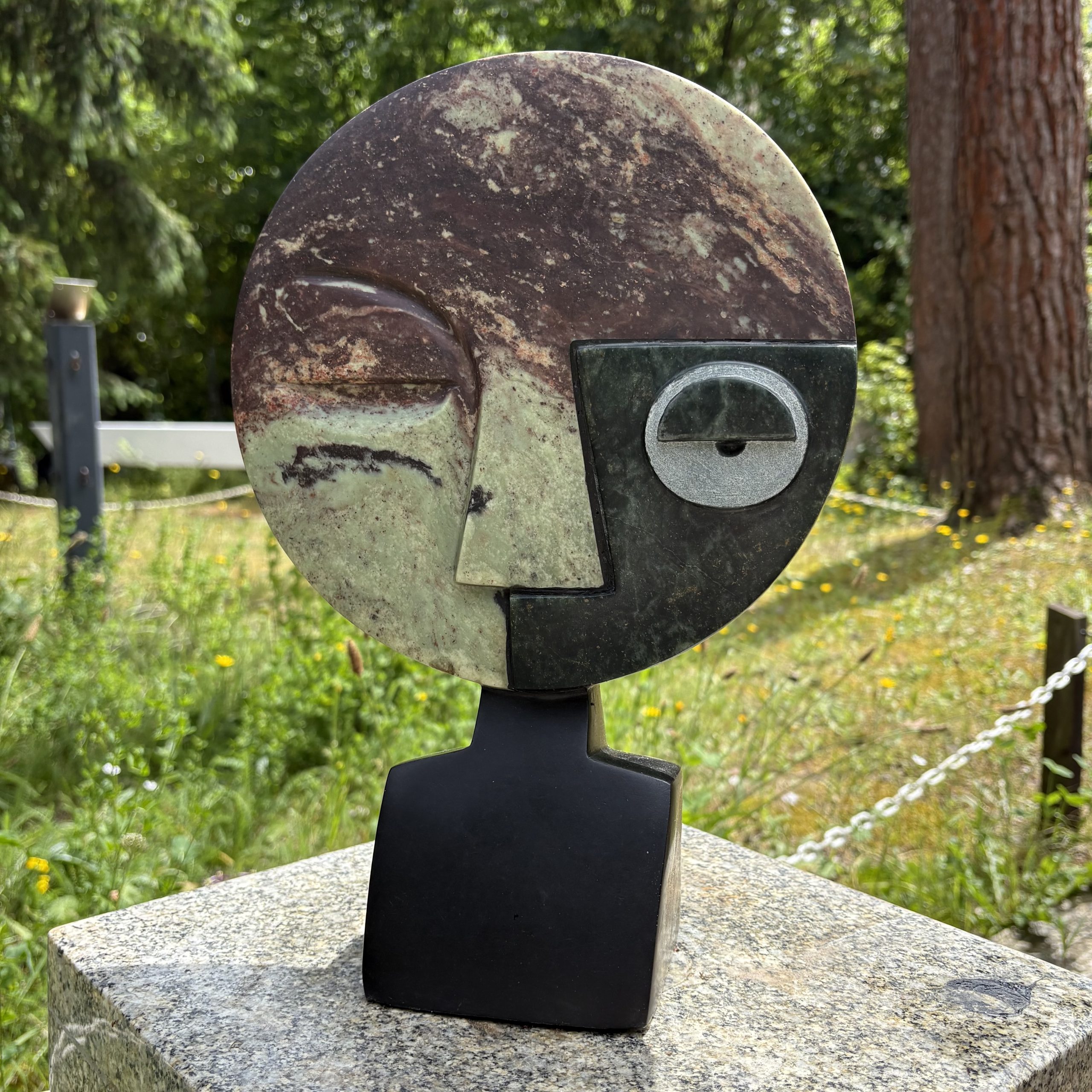 Visionary by Taylor Nkom. A unique, Cobalt, Opal and Springstone Shona sculpture of an abstract style face. The different stones add definition and colour.