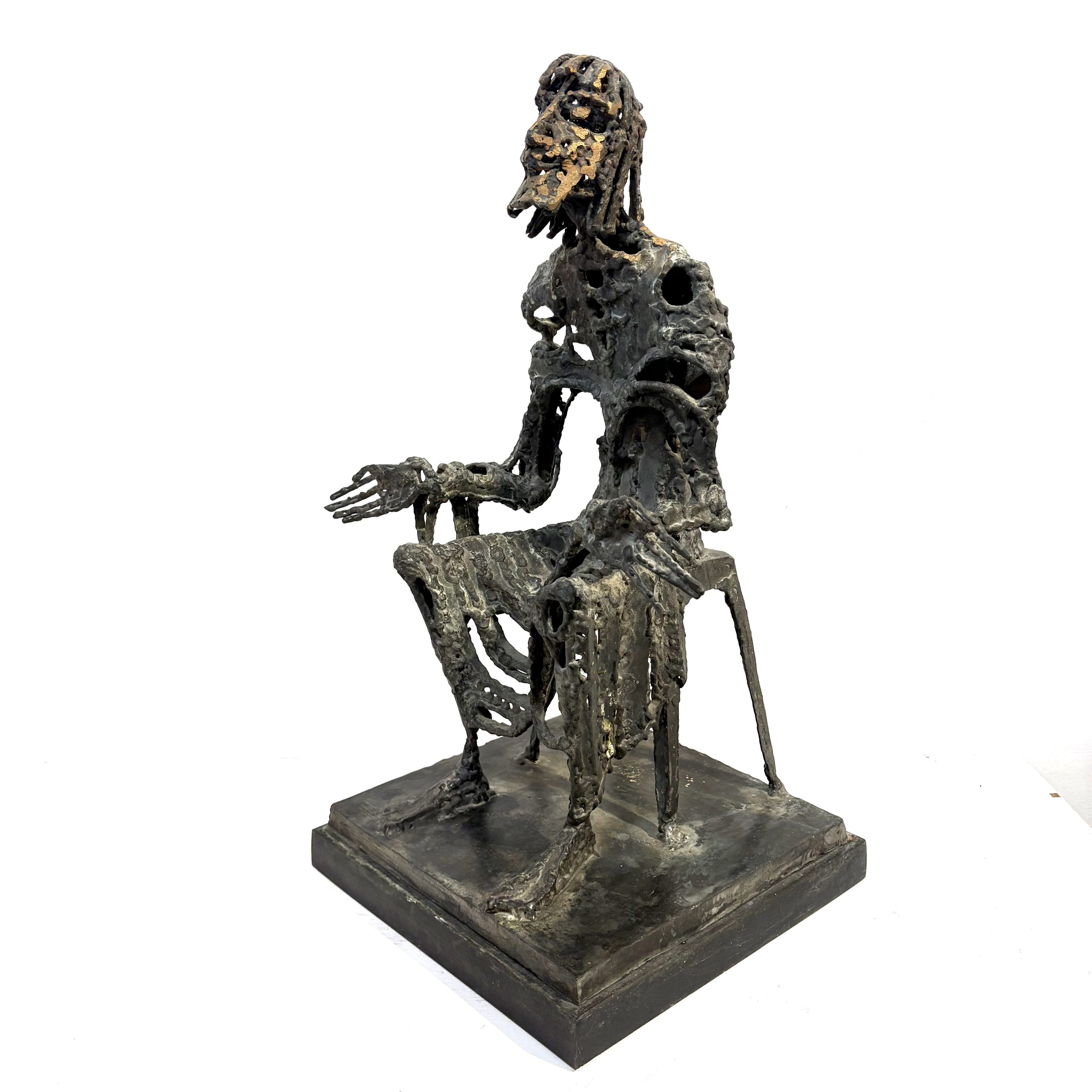 Judas by Sean Crampton. Table-top size bronze figurative sculpture of a seated man, Judas. Expressionistic in style.