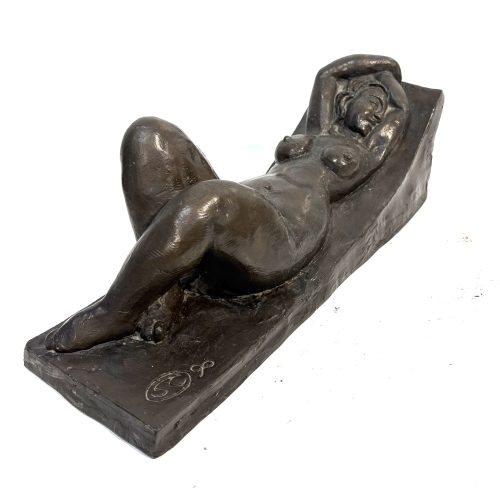 Reclining Nude on Lounger by Sean Crampton. Small bronze sculpture of a female figure lying down. she has a relaxed pose with hands behind her head, knees bent and feet crossed over.