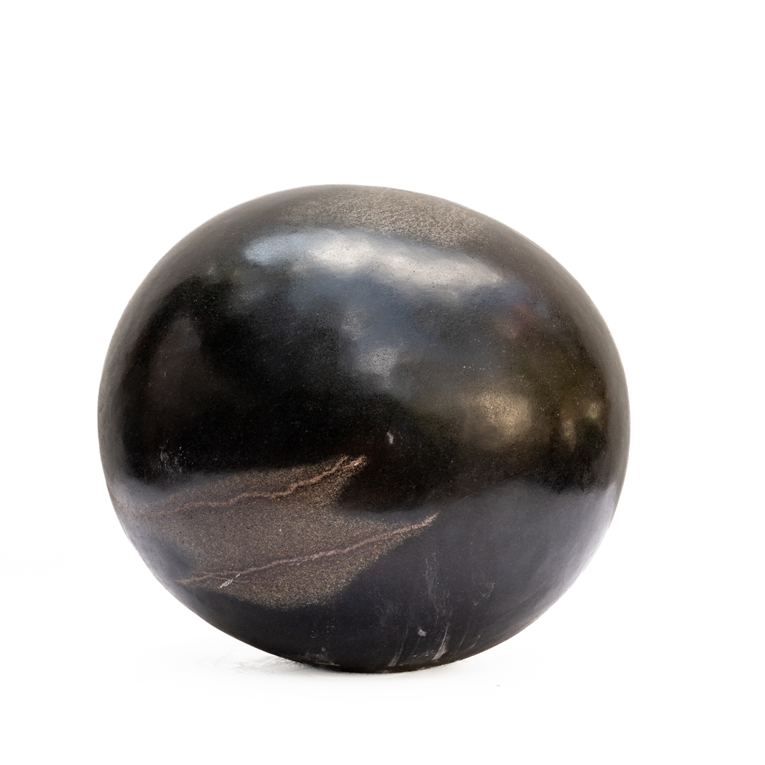 Sun Face by Addington Nyamasoka, a Shona Springstone sculpture of a rounded head with a face.