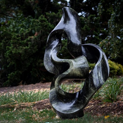 Healing Thoughts by Adrino Shephard Sikombo, a Shona Avocado Stone sculpture of a flowing curving abstract shape.