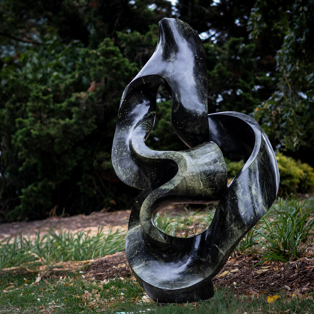 Healing Thoughts by Adrino Shephard Sikombo, a Shona Avocado Stone sculpture of a flowing curving abstract shape.