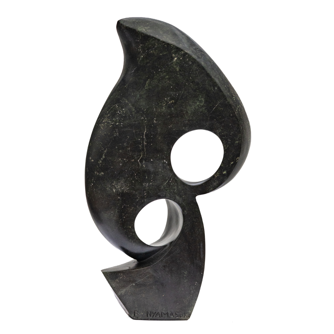 Opportunity by Evison Nyamasoka, a Shona Avocado stone sculpture of an abstract shape with two circles formed where the shape curles around itself.