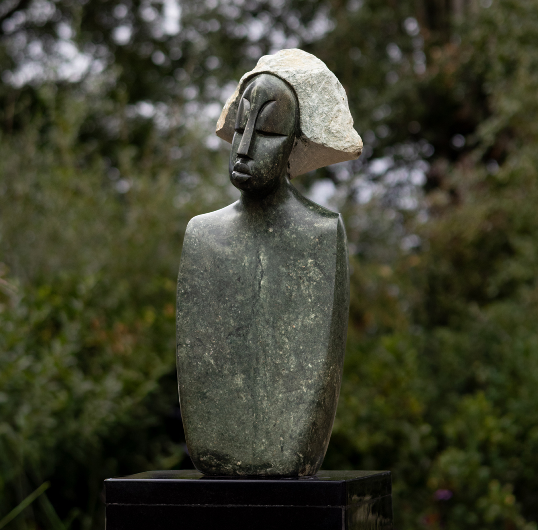 Proud Man by Wimbai Ngoma. Unique opal stone Shona bust sculpture. The hair has been left as the rough raw stone and contrasts in texture to the smooth face and shoulders.