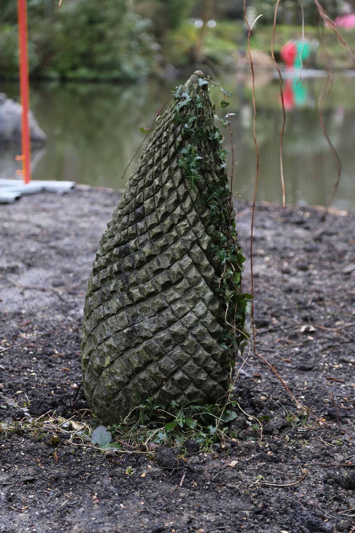 A floral clipsham stone sculpture of a small spiky pine cone.