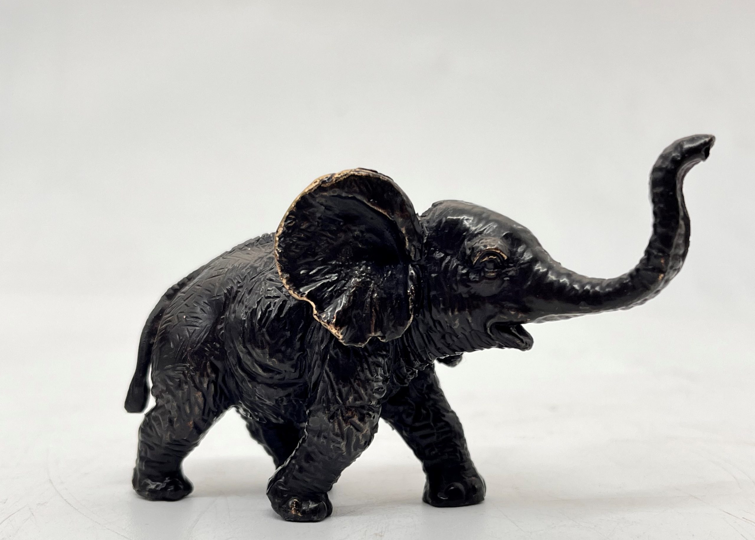 A decorative bronze resin sculpture of an African elephant and calf.
