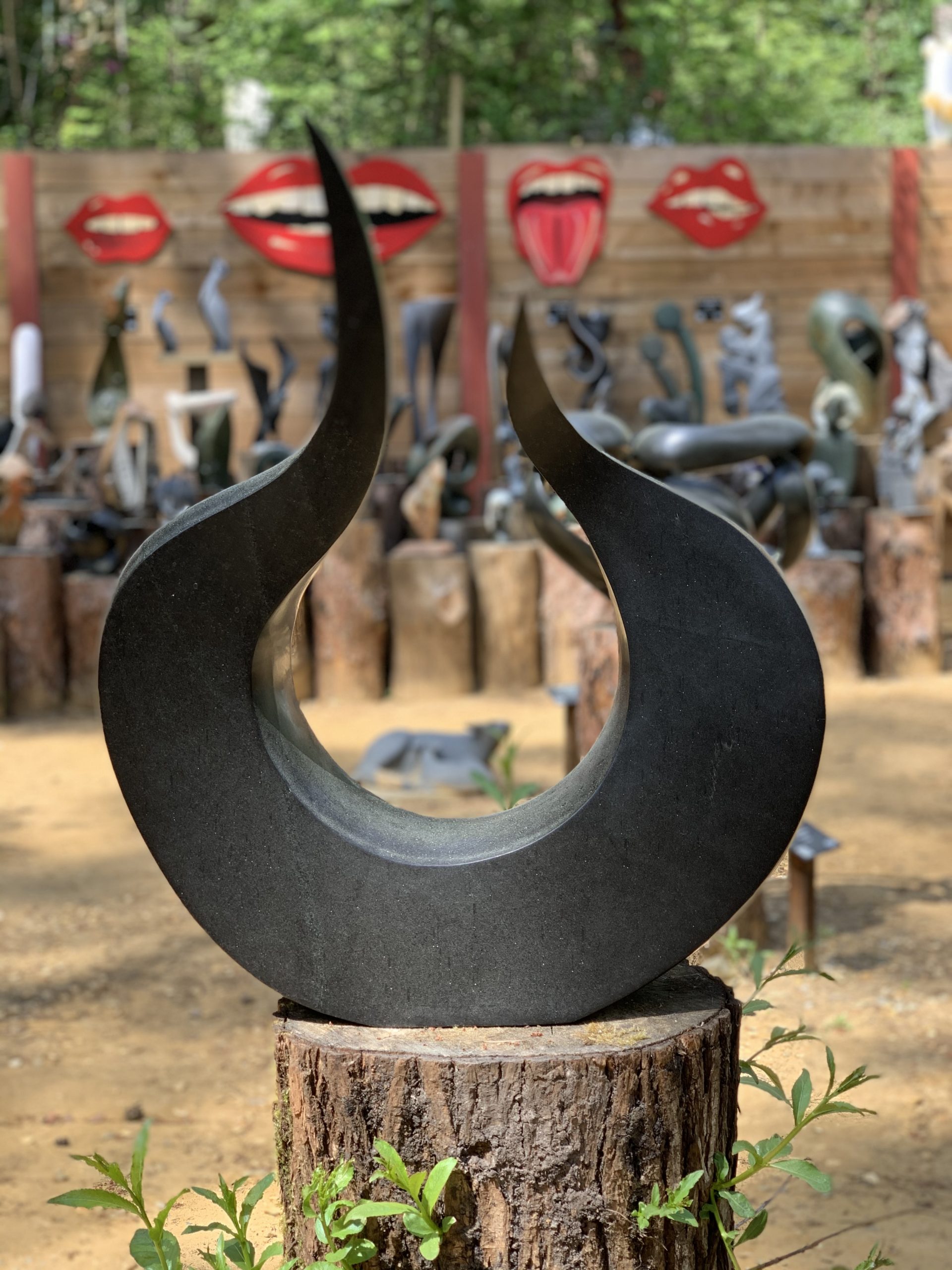 A abstract Shona springstone sculpture depicting a smoothly rounded and curved shape.