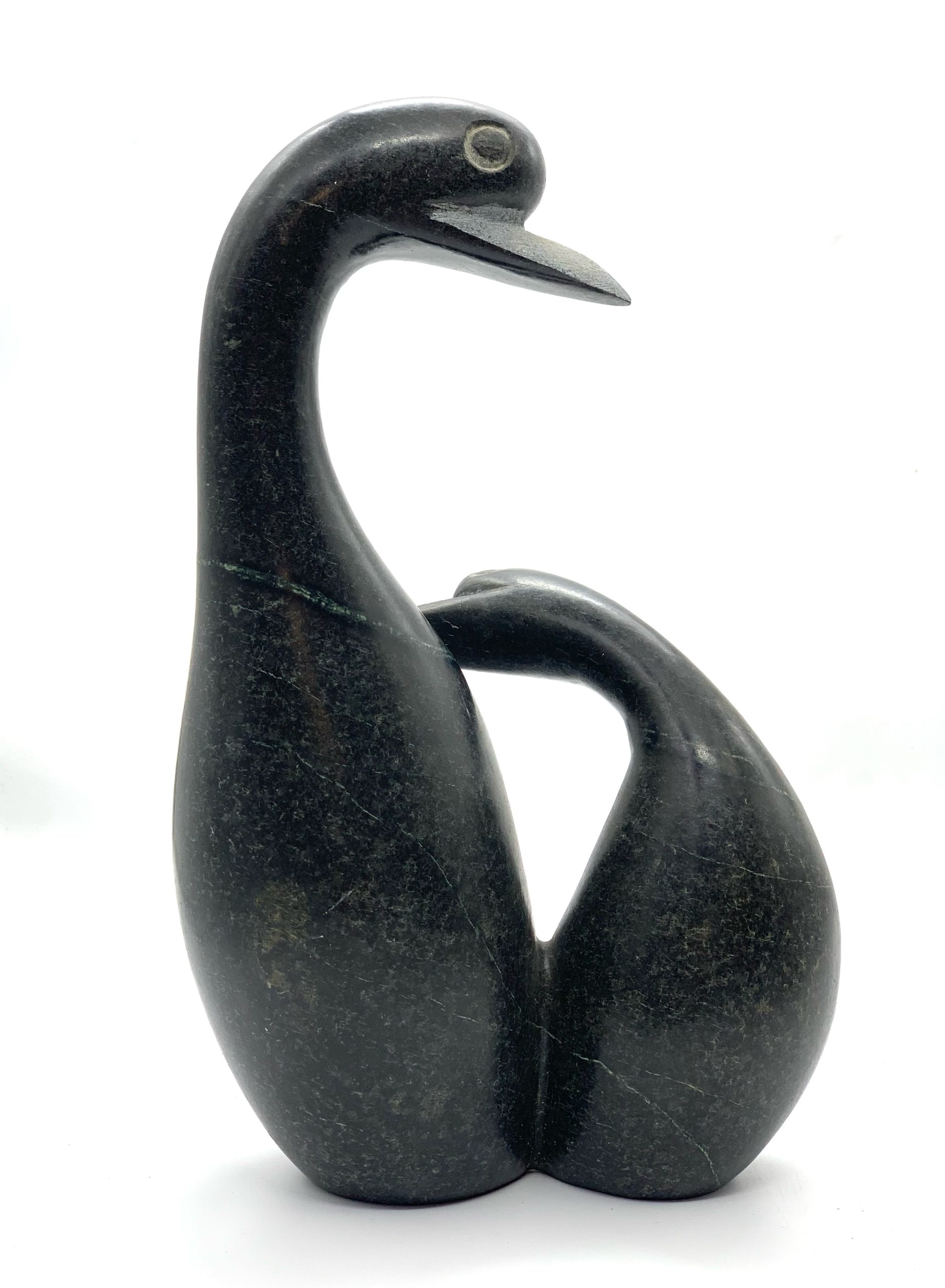 A smaller scale Shona sculpture made of Springstone showing 2 birds in an embrace.