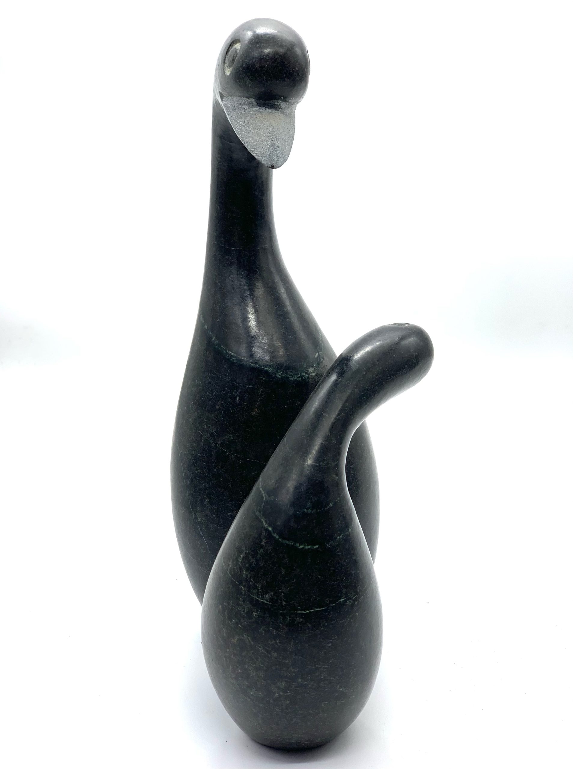 A smaller scale Shona sculpture made of Springstone showing 2 birds in an embrace.
