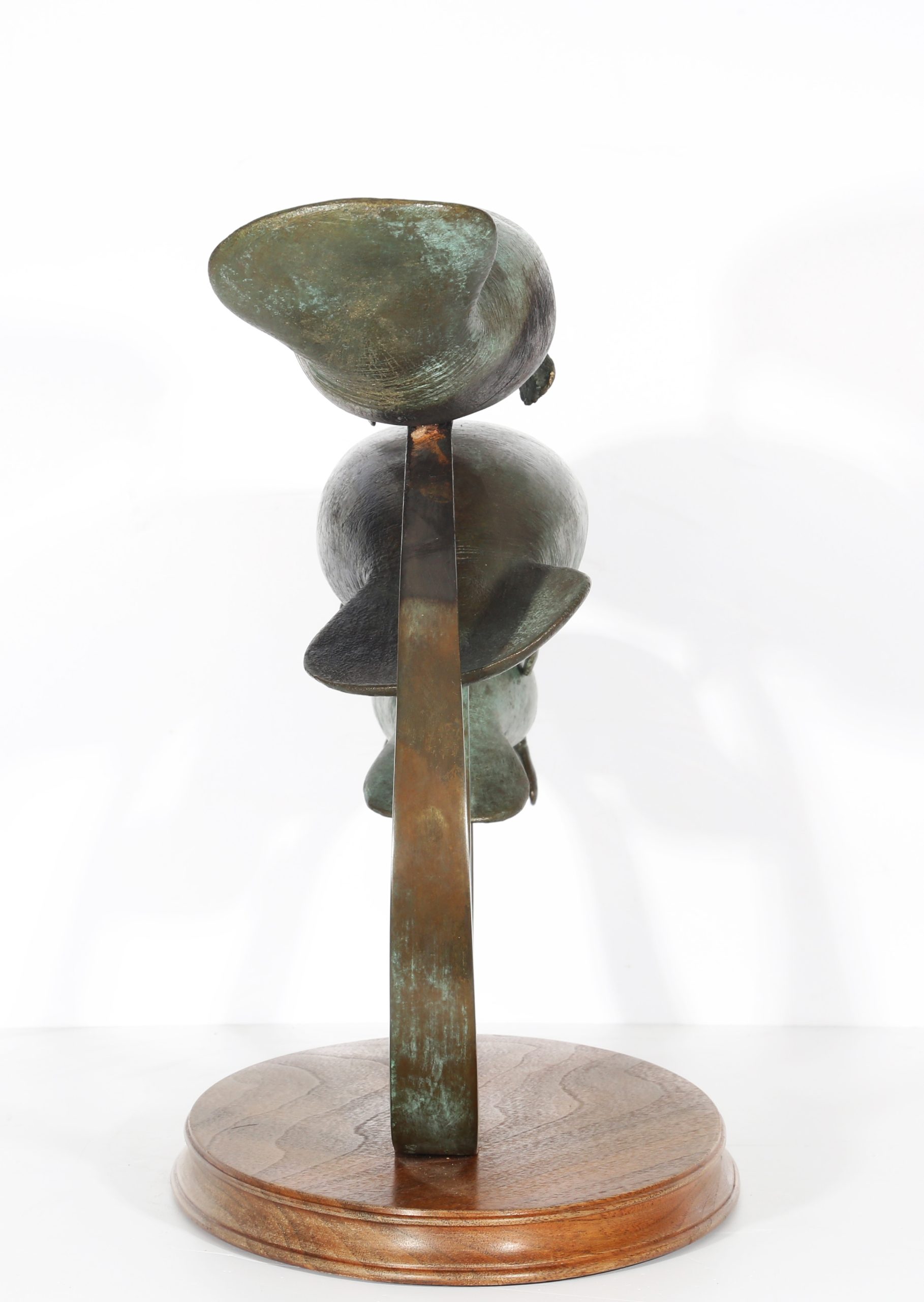 River Shadows by Andre Harvey is a Realistic bronze sculpture of 3 Manatees behind one another, each one slightly higher than the one before it. They are all being held up by a bronze rod to give them the effect of floating/swimming. On a wooden base.