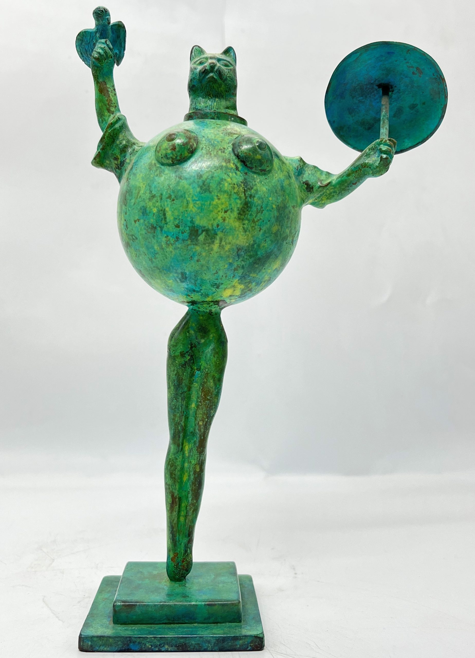 A modern and abstract smaller scale sculpture of a cat stood up straight whilst holding a bird in one hand and an umbrella in the other.
