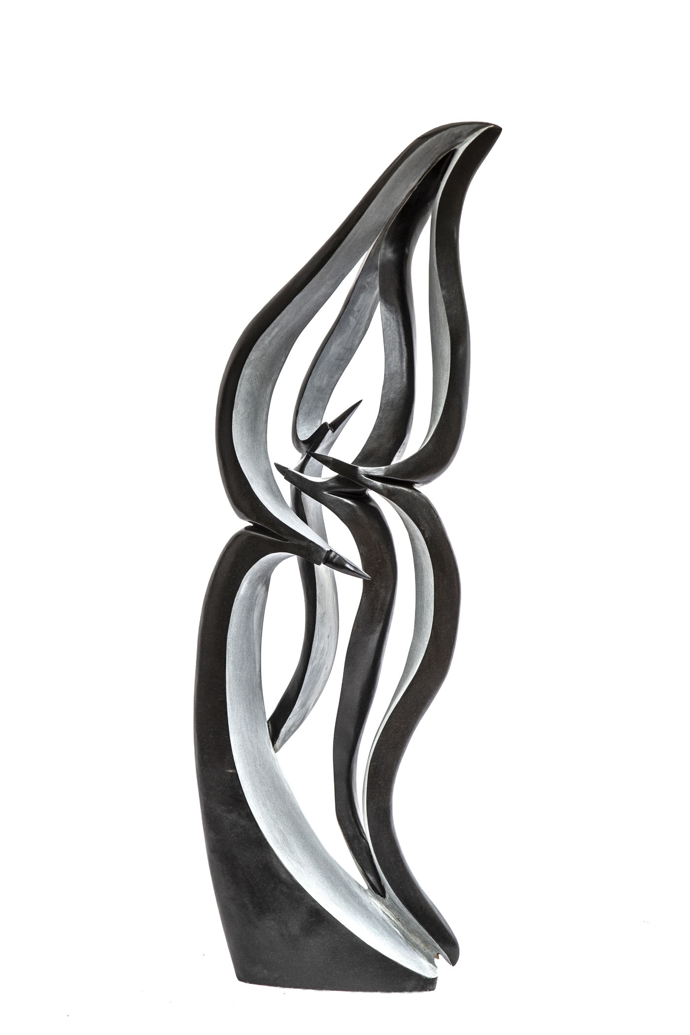 A shona springstone sculpture of a abstract curving shapes resembling a group of birds.