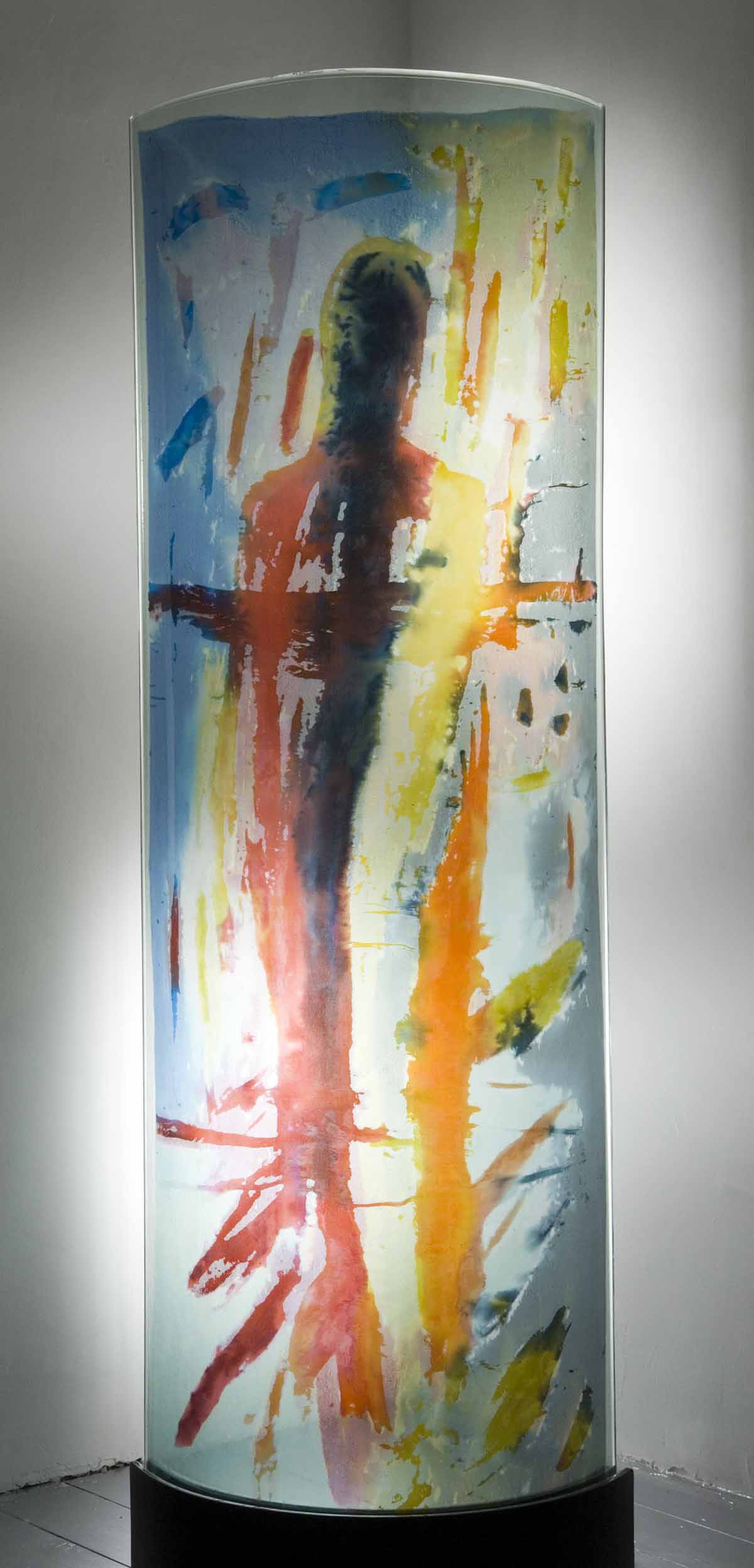 A abstract glass, resin and cloth sculpture of a painted abstract shape behind a glass panel.
