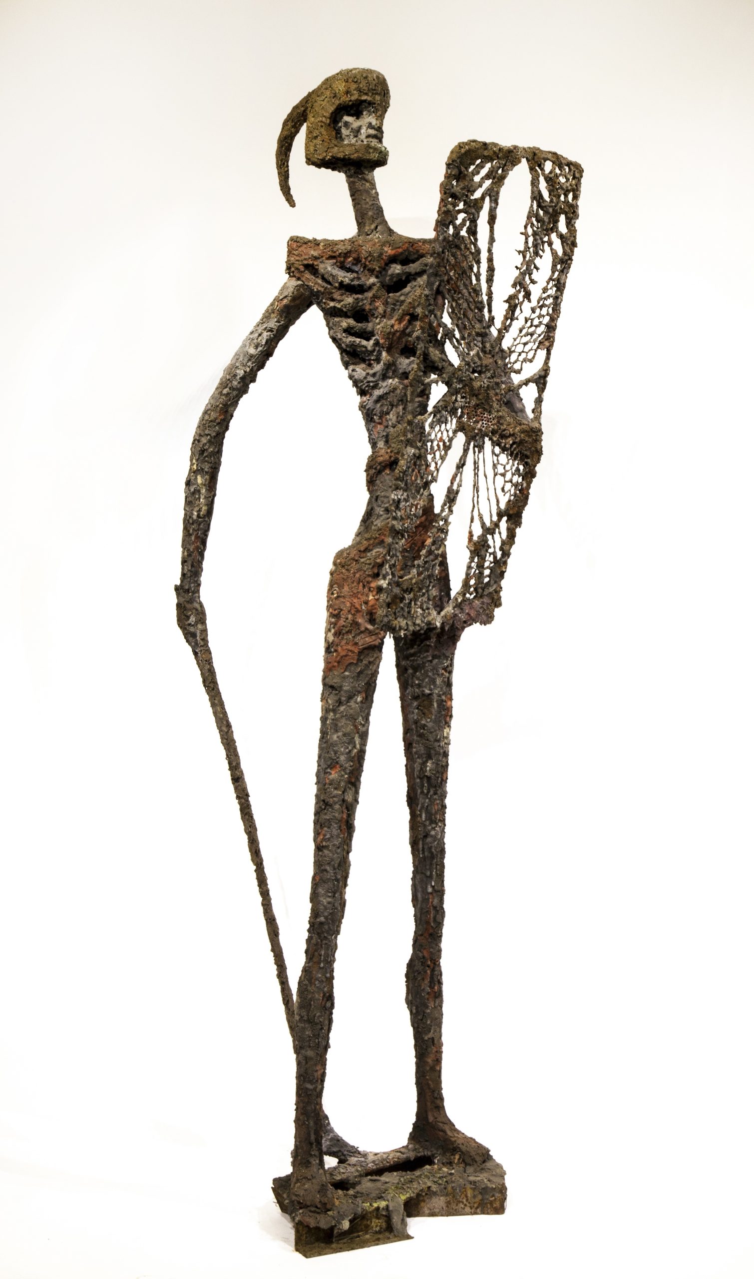 A figurative bronze resin sculpture of a abstract warrior standing with a sword and shield.