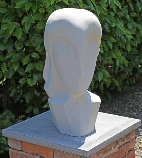 A figurative portland stone sculpture of a bust of a person.