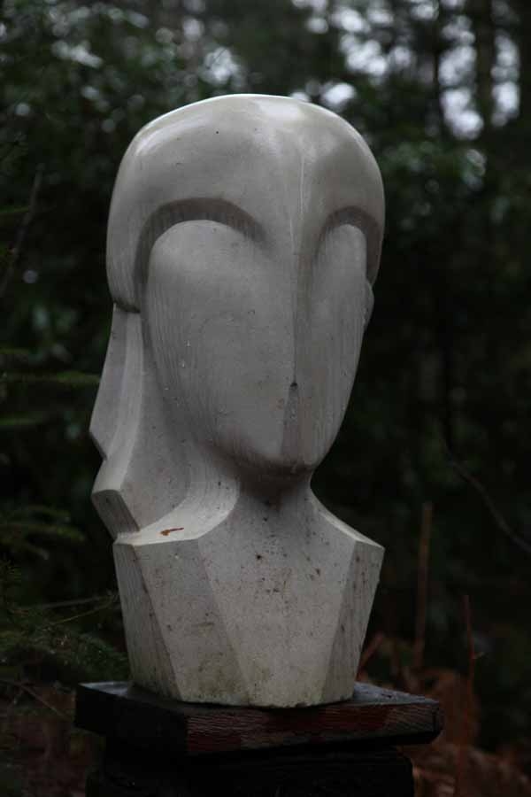 A figurative portland stone sculpture of a bust of a person.