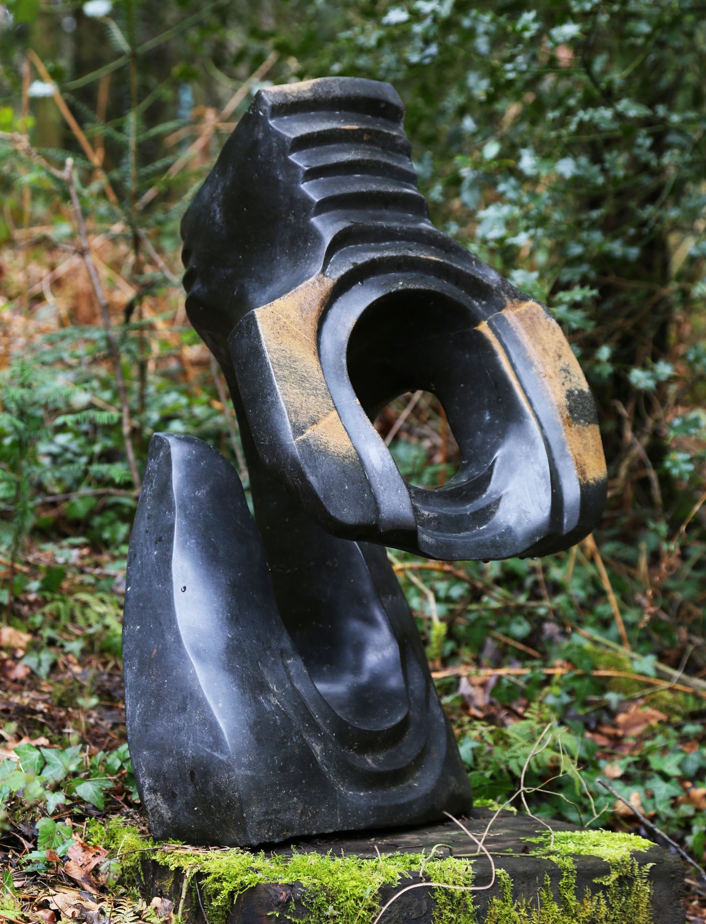 A shona springstone sculpture of a rippling abstract shape.