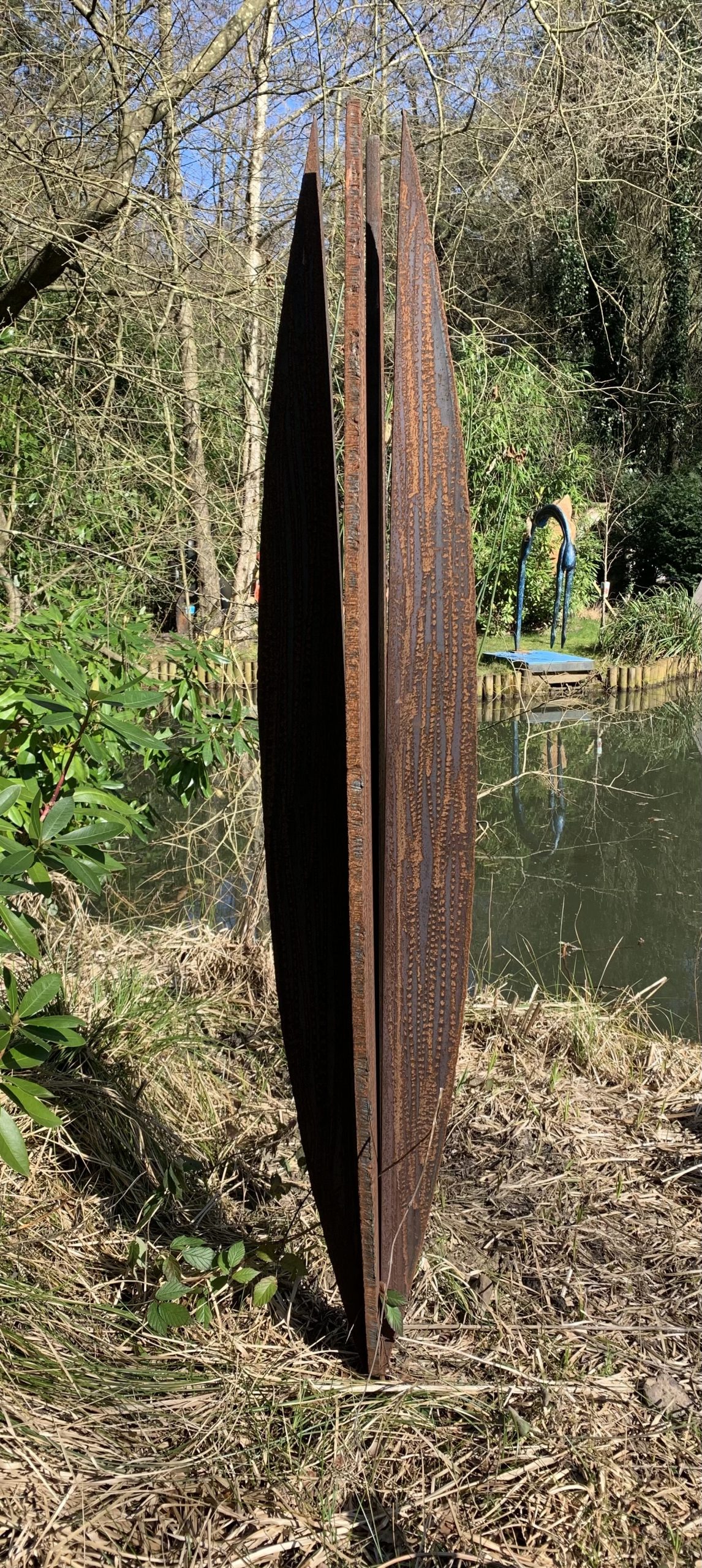 A abstract steel sculpture of an metal shape resembling a cypress tree.