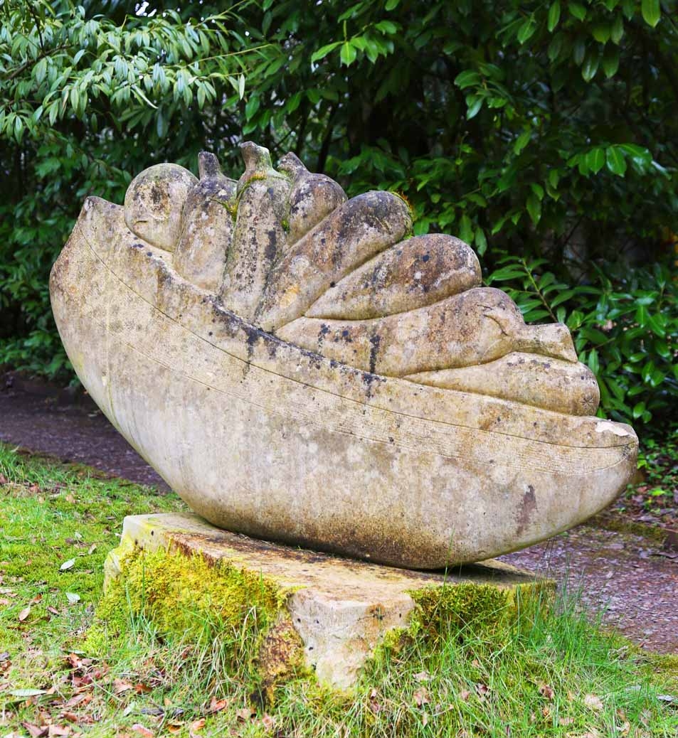 A abstract stone sculpture of a container full of vegetables.