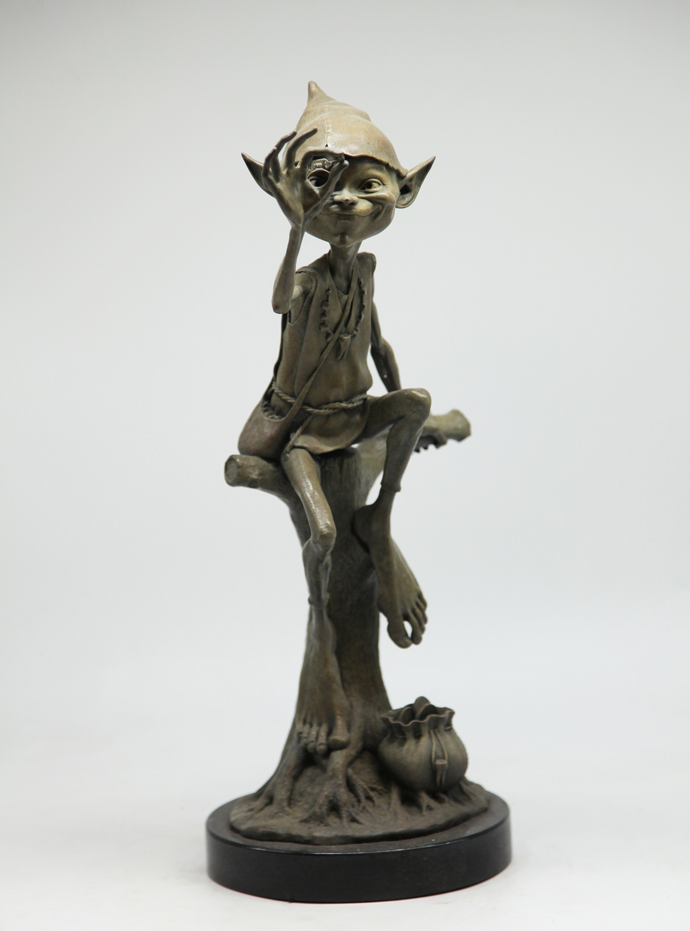 Adorable Bronze Figurative Goblin Sculpture depicting The Tooth Fairy, Inspecting a Tooth, his bag of coins by his side