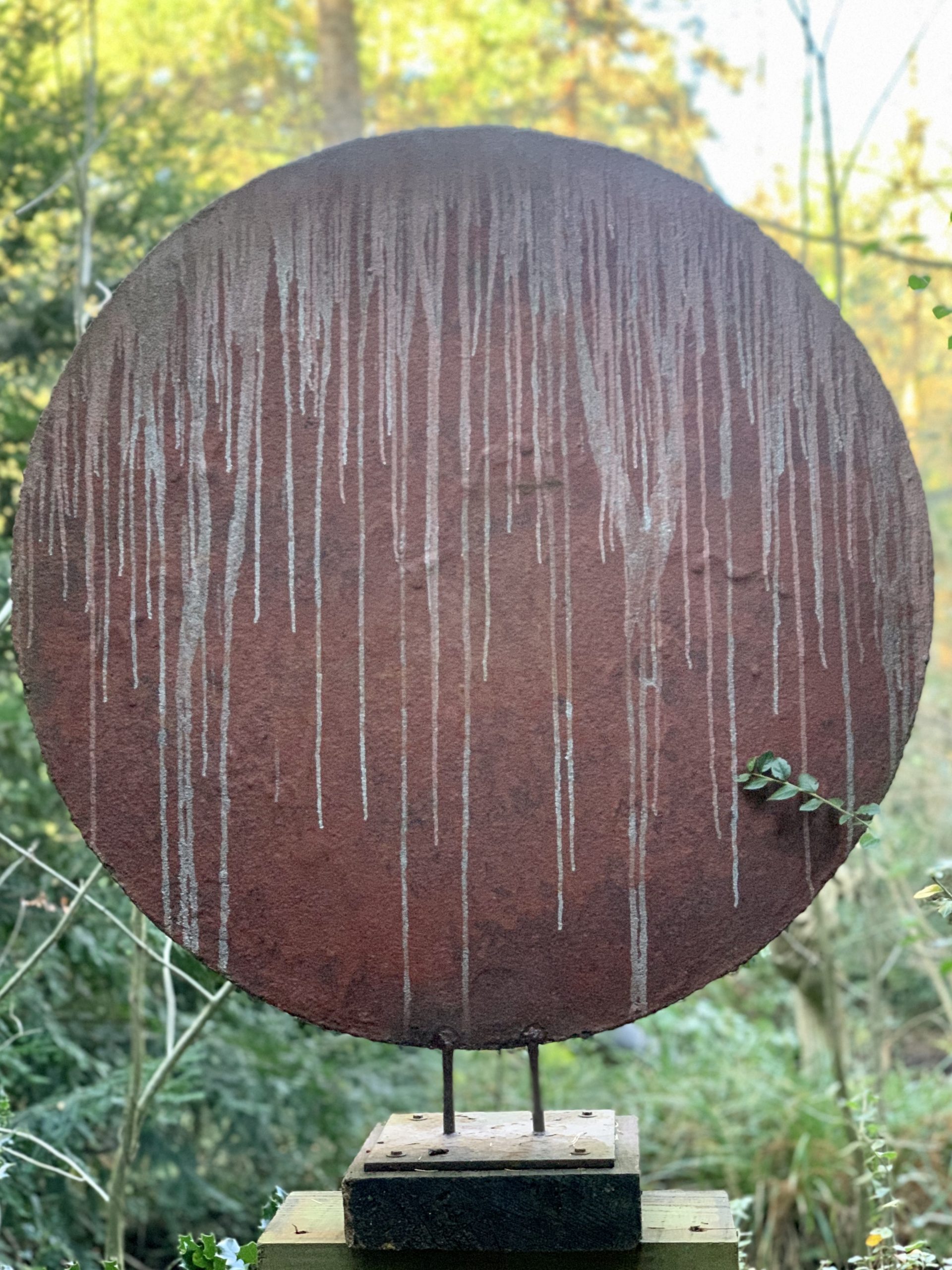 Round Red Steel Disk Depicting a Red Planet