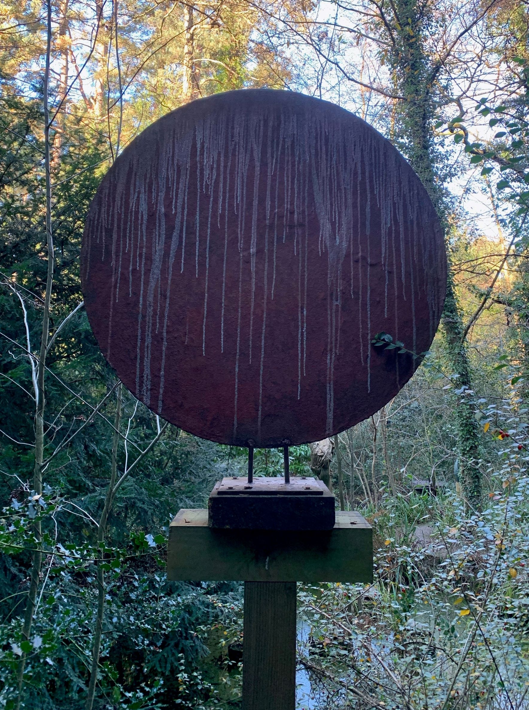 Round Red Steel Disk Depicting a Red Planet
