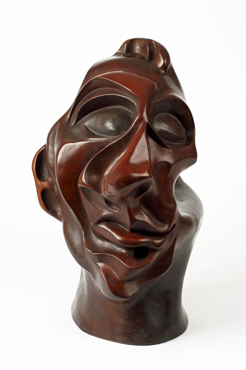 A figurative bronze sculpture of an expressionist depiction of a persons face.