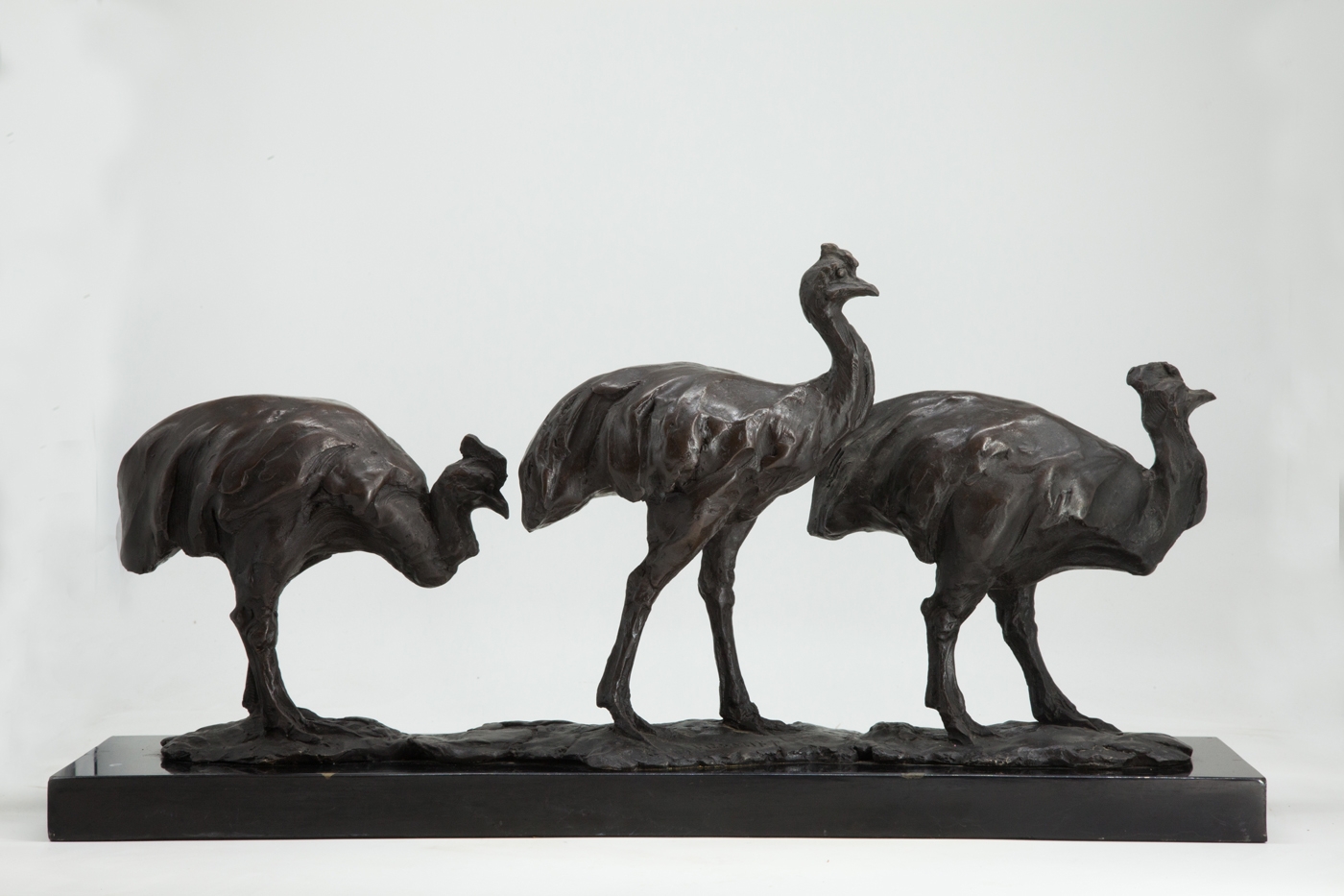 A smaller scale sculpture of three Cassowary birds standing behind each other.