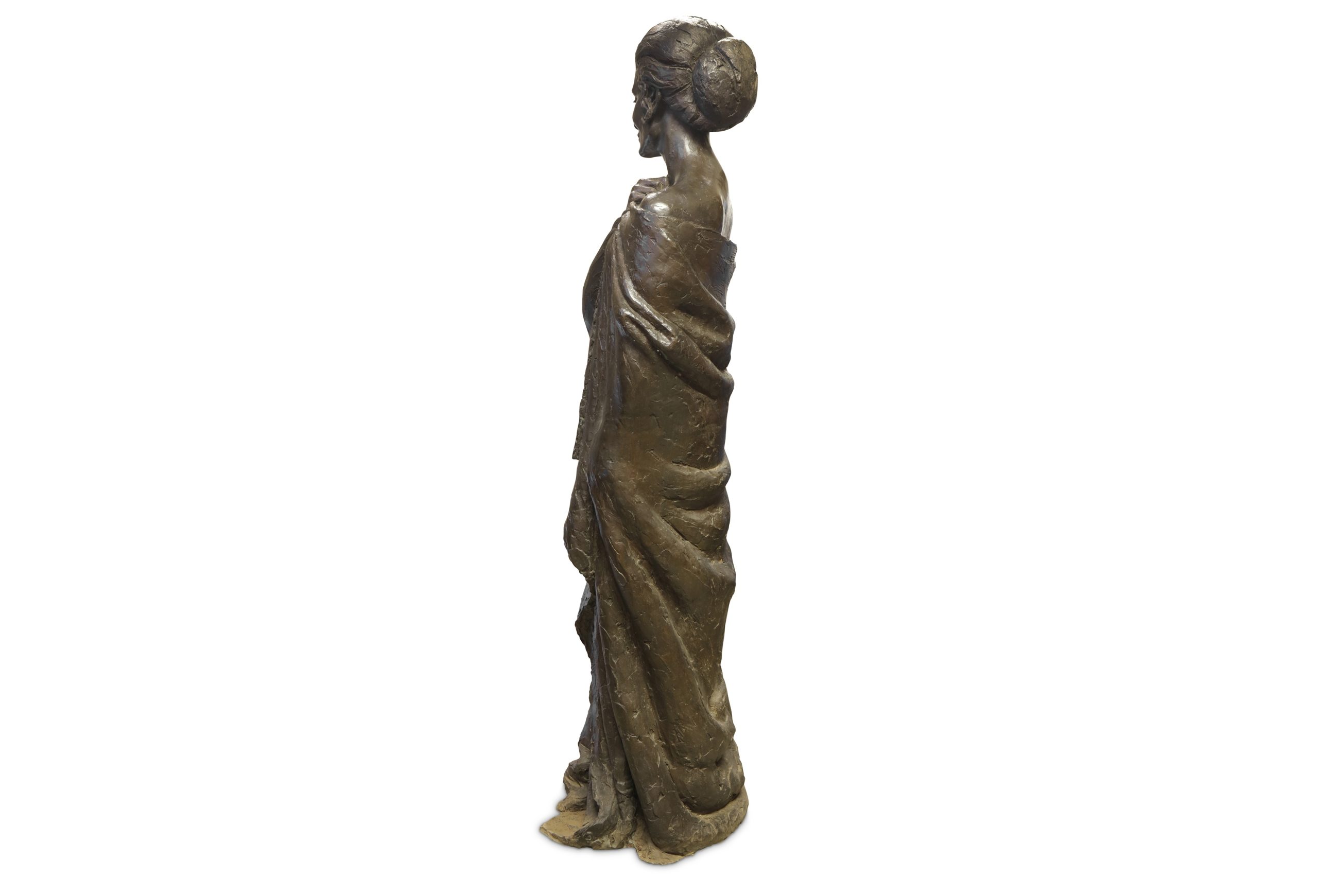 A bronze with black patina sculpture of a woman smiling and wearing a cloak.